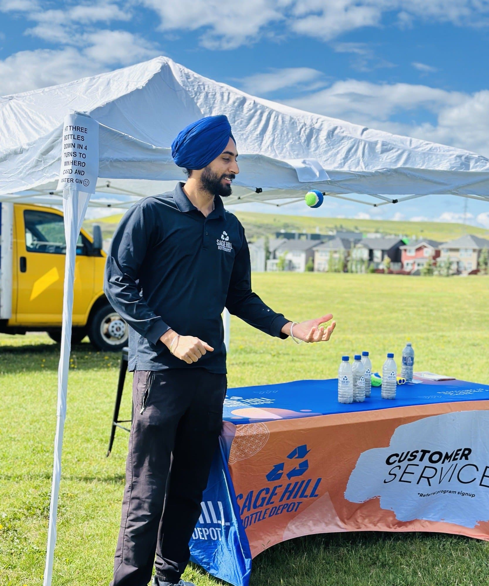 Sage Hill Bottle Depot staff at a community bottle drive event booth